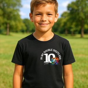 Smiling boy wearing black personalised 10th birthday t-shirt with football design and name Sam, outdoors.