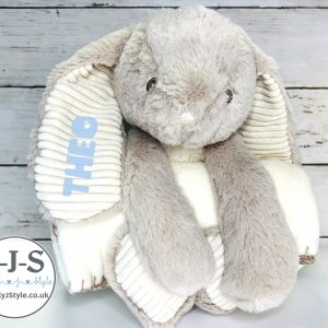 Soft plush bunny with light blue personalised name on ear, holding cream fleece blanket